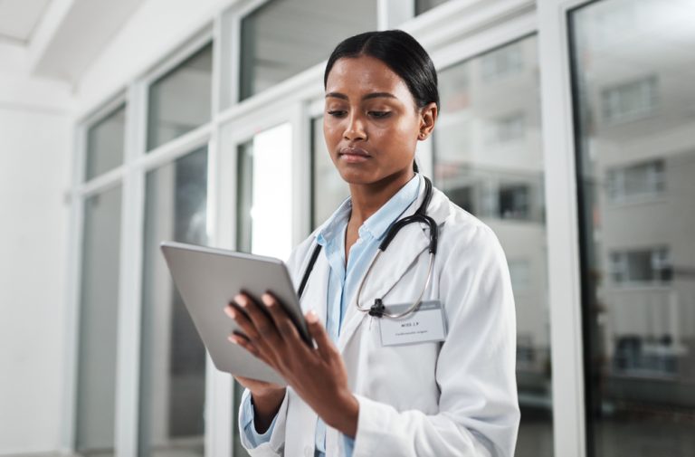 doctor entering notes into digital record-keeping platform